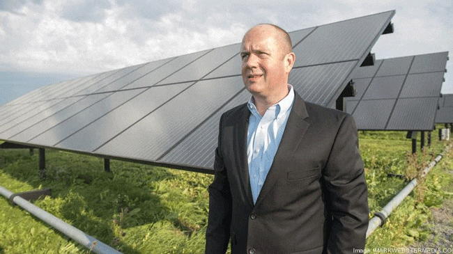Rob Gauchat in front of solar panels
