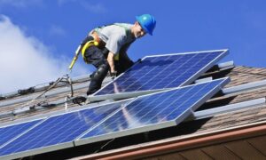 Solar Liberty installer working on pitched roof residential install