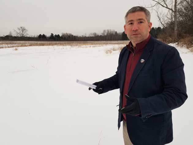 Man in front of snowy field
