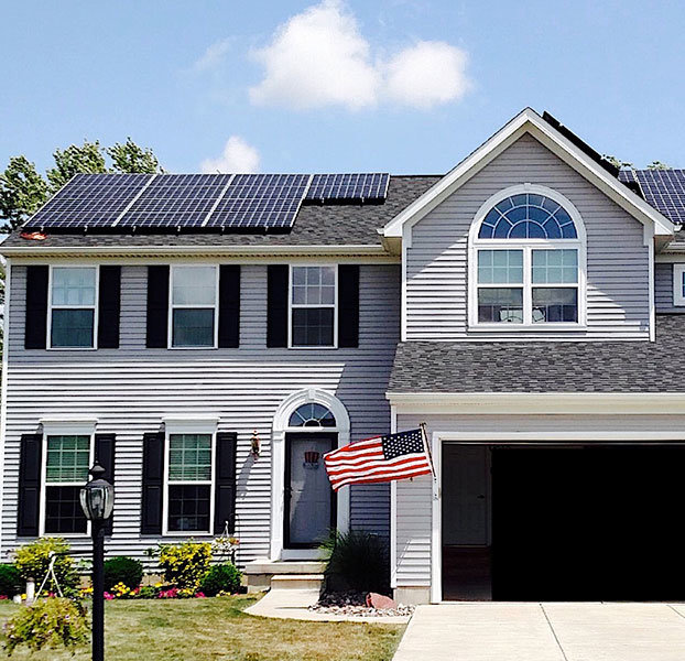 House with solar and American flag