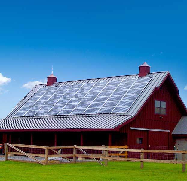 solar panels on red barn rooftop