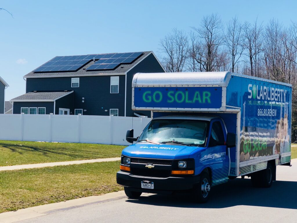 Solar Liberty truck in front of house with brand new solar panels